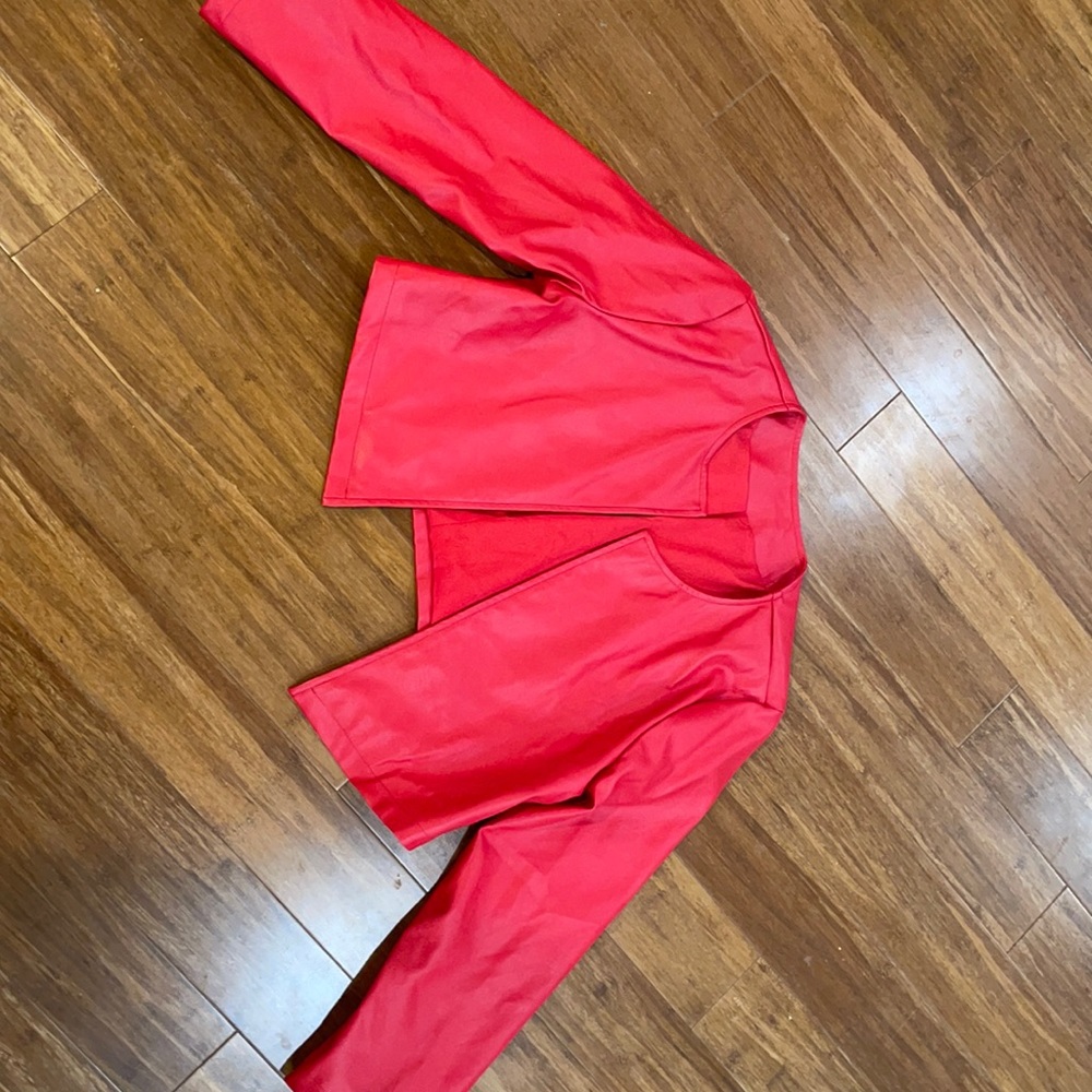 Faux leather red jacket. It is unworn. Size medium and is a crop top.Super comfy